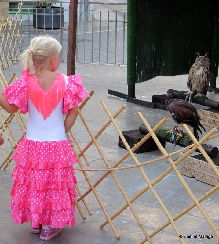 Little girl in traditional flamenco dress at the medieval market, Torrox pueblo.