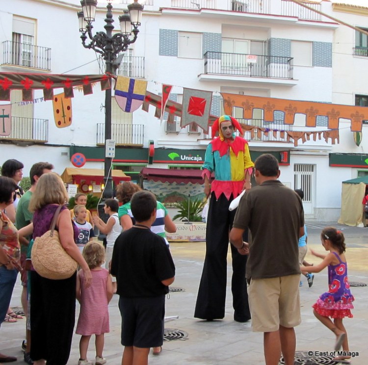 Jester on stilts entertains at the medieval market in Torrox pueblo