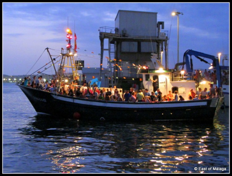 Excited people crowd onto the boats