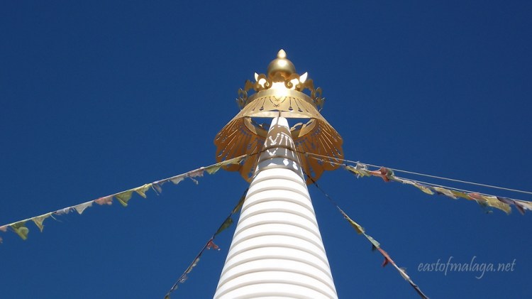 The golden dome of the Stupa glistens in the beautiful sunshine