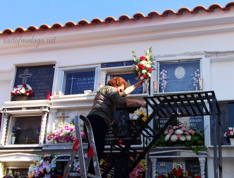 Climbing up the steps to tend the grave in Competa, Spain