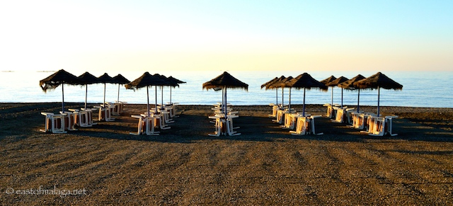Early morning sun strikes the waiting sun beds - Torre del Mar, Spain