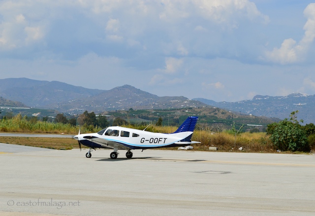 Can you see the aircraft about to land (on the far right of the photo), just below the village of Comares?