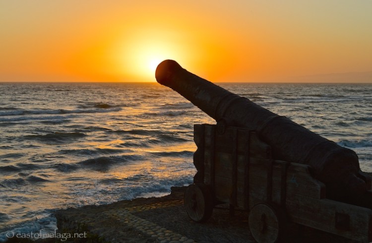 Sunset behind the cannon at Torrox Costa, Spain
